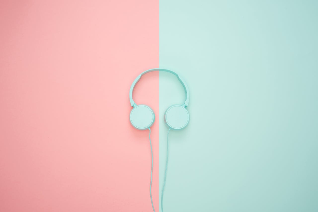 Crafting Captivating Headlines: Your awesome post title goes here Minimalist headphones on a pink and mint background, artistic and modern.