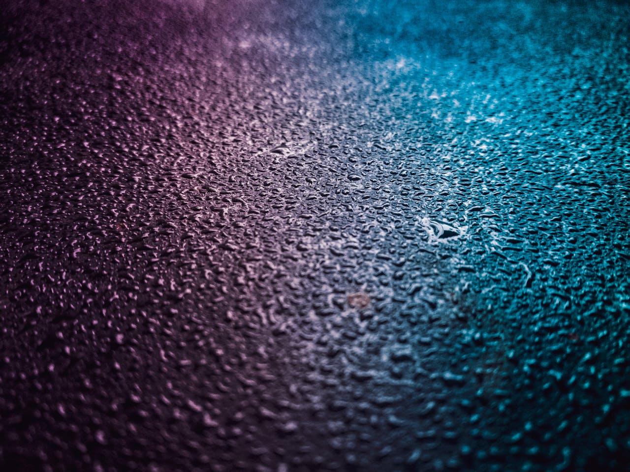 The Art of Drawing Readers In: Your attractive post title goes here Close-up of vibrant water droplets on a textured surface, featuring pink and blue gradient lighting.
